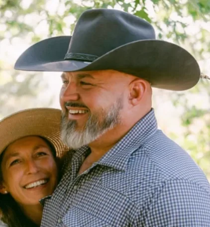 Portrait of Ian Bennett in a cowboy hat with Jill